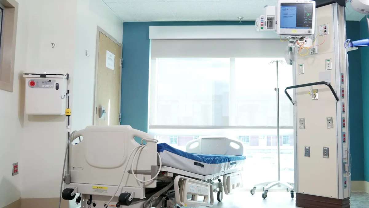 Quarto de hospital bem equipado, com cama e equipamentos médicos